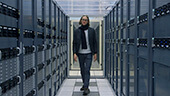 Still image of Dr. James Beacham walks the data corridor at CERN
